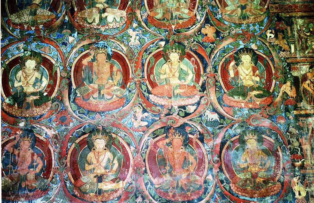 Tibet Guge 03 Tholing 04 Red Temple Many Images Along the left hand wall are floor-to-ceiling rows of deities entwined in wreath-like borders each interleaving into a whole organic complex across the entire space. Photo - Thni: Westtibet.